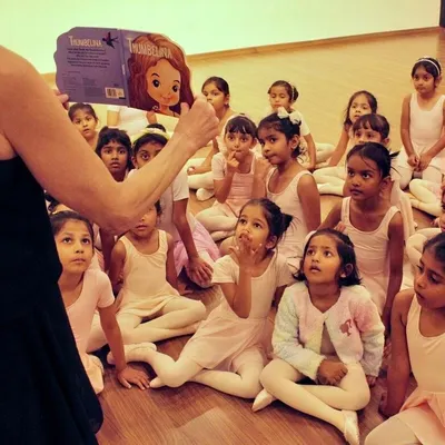Storytime sparks the imagination before we even take a step. Here, our little dancers are captivated by the tale of Thumbelina, connecting narrative to movement and learning the basics of ballet through play.