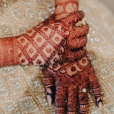 The deep, rich color of the mature henna stain is a result of high-quality, natural ingredients and proper aftercare. This close-up shows the beautiful contrast of the design on the skin.