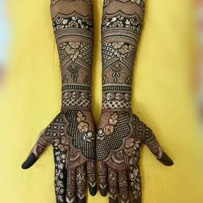 This full-arm design combines delicate rose motifs with complex geometric patterns. The contrast between the floral elements and the fine-line work creates a balanced and beautiful result.