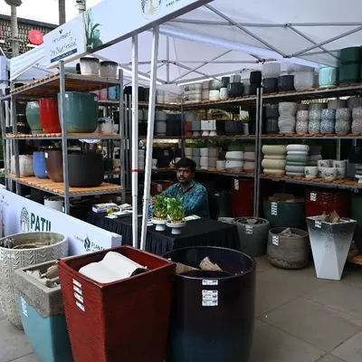 Our booth at a plant festival, dedicated entirely to our extensive collection of planters. We source a wide variety of materials, colors, and sizes, from large outdoor pots to small, decorative indoor ones.