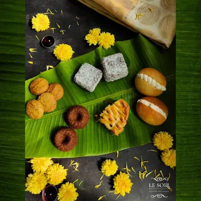 This is a glimpse of my 'Nandi 2024' Onam menu, a special collection I created to thank my wonderful Malayali clients. It features fusion bakes like Unniappam cakes, Butter Buns, and Masala Biscuits.