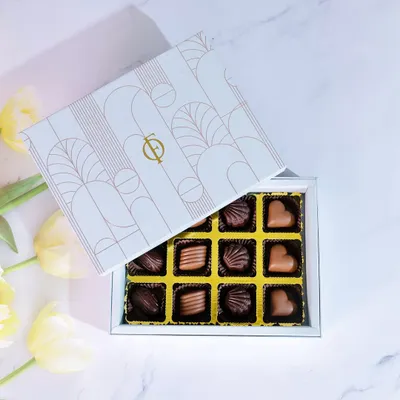 Indulgence, beautifully boxed. Our 12-piece praline collection features a variety of handcrafted chocolates, perfect for gifting or as a personal treat.