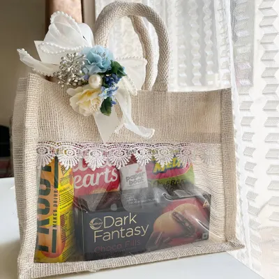 Make your destination wedding guests feel welcome the moment they arrive. This custom jute welcome bag is filled with snacks, drinks, and essentials, all beautifully presented with lace detailing and a floral touch to match your wedding theme.