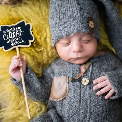 We think this little sign says it all. This newborn portrait, with the baby in a cozy knit outfit, highlights the cute and funny details we love to include in our sessions.