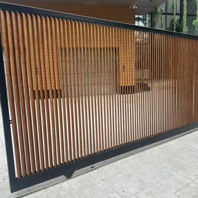 Your main gate is the first impression of your home. This custom sliding gate uses our durable, low-maintenance Tipwood in a vertical slat design, blending security with modern aesthetics.