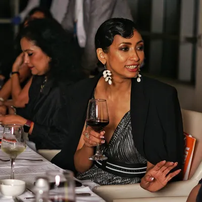 A candid shot of a guest completely absorbed in the moment during a dinner event. I look for these natural expressions that tell a story without words, capturing the authentic mood of your celebration.