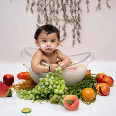 A refreshing and fun milk and fruit bath session. This unique photoshoot is a wonderful way to capture your baby's playful side as they explore different textures and tastes.