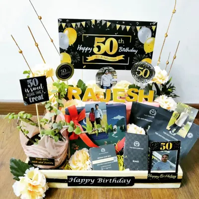 Marking a 50th birthday calls for something special. This elegant black and gold themed hamper includes a live plant, premium snacks, and is personalized with the recipient's name and photos to honor their big day.