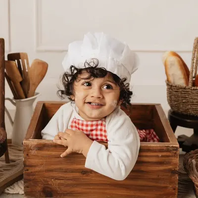 Another angle from our adorable baby baker theme, with a chef's hat and a basket of bread.