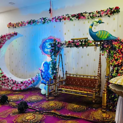 Flowers make everything more beautiful. For this setup, I created a large crescent moon completely out of flowers, which became the centerpiece of the decor. I also used floral arrangements to adorn the traditional swing and the peacock figure.