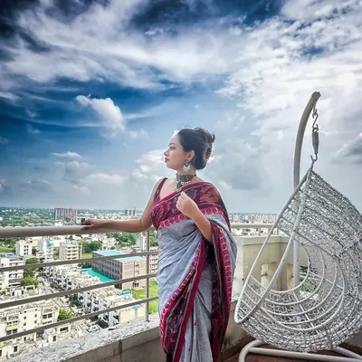 A dramatic shot of my grey and maroon Ikat saree against a cloudy sky. Handloom fabrics like Ikat have a rich texture and story that makes any look feel special.