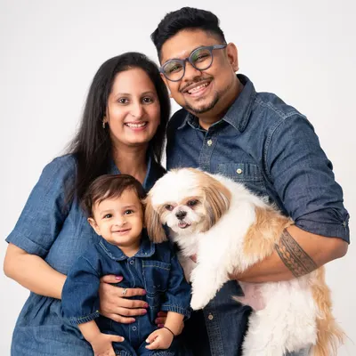The perfect family portrait includes everyone, even the furry members. This beautiful family, with their one-year-old and their adorable Shih Tzu, is a great example of the love I aim to capture.