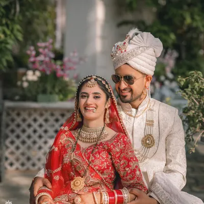 A joyful, candid moment between the bride and groom during their wedding portraits at the beautiful Woodville Palace in Shimla.