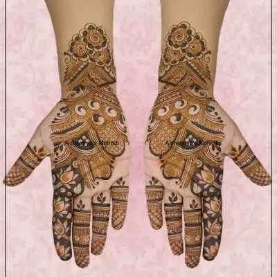 A beautiful Arabic mehndi design featuring a large peacock-inspired motif that flows from the palm to the wrist, combined with delicate floral details.