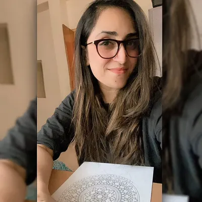 Hey, I'm Bhagyashree! This is me with one of my classic black and white mandalas. I'm the face behind all the art you see here, and I'm so happy to share my creative journey with you.