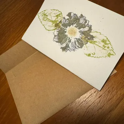 A single handcrafted greeting card featuring a beautiful botanical print. Made on high-quality watercolour paper, the design is created by directly imprinting real flowers and leaves, making each card a unique piece of art.