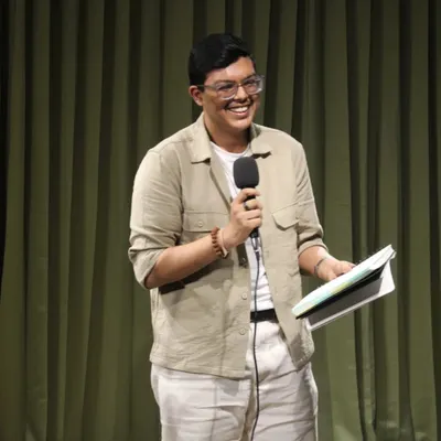 That smile says it all! A performer lights up the stage during "The Bean Grill" open mic, sharing their passion with an appreciative audience. Our space is perfect for these intimate performance events.