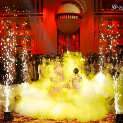 A spectacular groom's entry, complete with colored smoke and cold pyro, creating a dramatic and unforgettable start to the wedding ceremony. We are equipped to capture these grand moments perfectly.