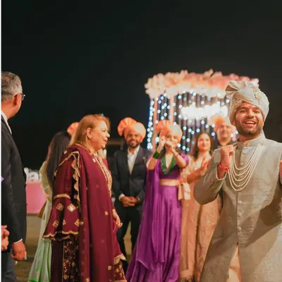 The groom's infectious energy during the Baraat. This shot captures the pure joy and excitement of the groom's procession.