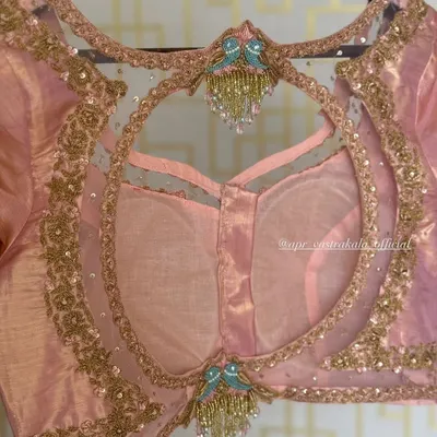 A beautiful example of a sheer back blouse with a large circular cutout. The design is embellished with bird motifs and delicate tassels, creating a look that is both elegant and playful.