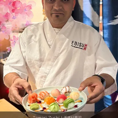 Our chef proudly presents a plate of Temari Zushi from our seasonal Sakura Menu. These bite-sized sushi balls are a celebration of delicate craftsmanship and the freshest ingredients, reflecting the beauty of spring in Japan.