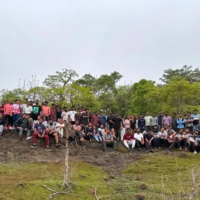 A large corporate group poses for a photo after a successful trek in Ananthagiri Hills. We love hosting big teams and helping them create shared memories.