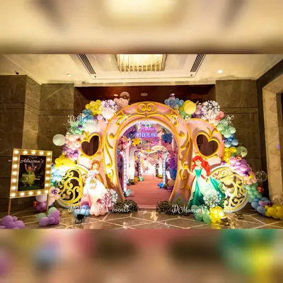 A magnificent princess carriage archway makes for a grand entrance, welcoming guests to a wonderland of pastel balloons and beloved princess characters.