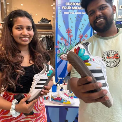 Us with a happy customer at our Adidas customization event. We painted these Adidas Sambas with a vibrant, nature-inspired floral design, creating a unique pair right in the store.