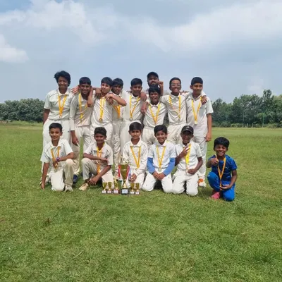 Our victorious U12 cricket team posing with their medals and trophies after being crowned champions at the CBT tournament. A proud moment for the players, coaches, and parents.
