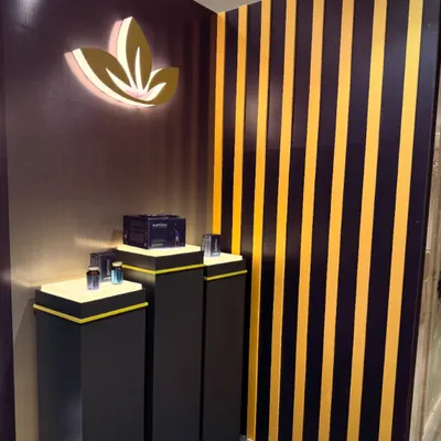 A sleek and modern exhibition stall designed for a healthcare product launch. The design uses bold stripes, illuminated pedestals, and a backlit logo to create a sophisticated and eye-catching display for corporate and pharma events.