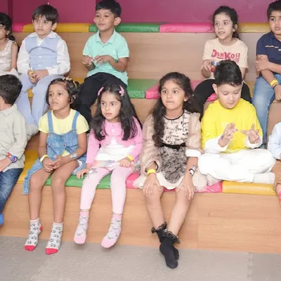 A group of young guests sitting in our tiered seating area, watching a magic show or movie screening.