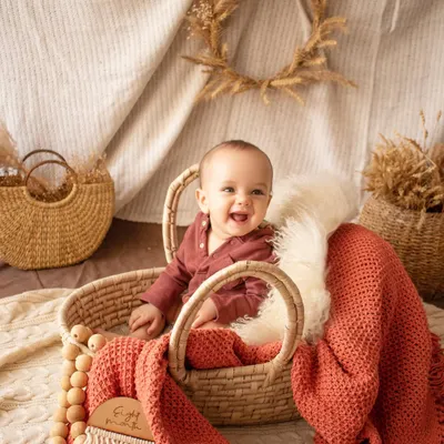 Look at that happy smile. Sitter sessions, for babies who can sit up on their own, are full of personality. I use simple, rustic props like this wicker basket to keep the focus on your baby's expressions.