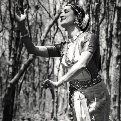A black and white portrait from a photoshoot in the woods. The natural textures of the forest create a beautiful, timeless backdrop for the dance posture.