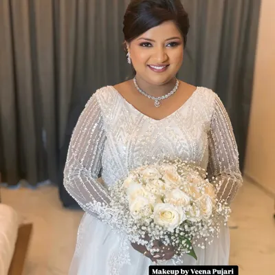 A beautiful and happy bride ready for her church wedding. I created a soft, radiant look with a classic updo to perfectly complement her stunning white gown and bouquet.