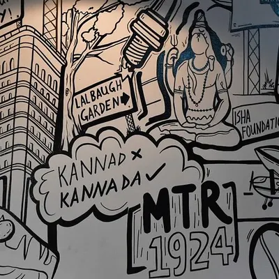 A close-up of our 'Namma Bengaluru' doodle art, showing details like the Isha Foundation Adiyogi statue and Lalbagh Garden signs. This kind of detailed line art is perfect for giving customers something new to discover with every visit.