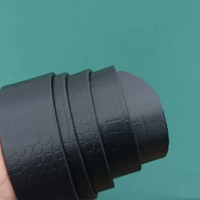 A close-up of my black leather belt, showing the subtle honeycomb texture of the crocodile-style leather.