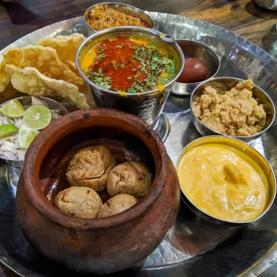 Food quality is my top priority, and this authentic Rajasthani thali shows my commitment to flavor. It features freshly made Dal Baati served in a traditional clay pot, Churma, zesty Kadhi, and other accompaniments for a complete regional meal.