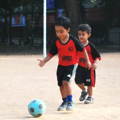 Little feet, big passion. My toddler program is all about introducing the beautiful game through fun and play. Here, two of our youngest players are completely focused on the ball, learning the basics of control and movement.