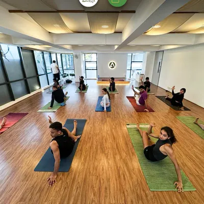 A look inside our studio during a restorative yoga session. We believe in creating a serene environment where you can focus on your practice and find your balance.