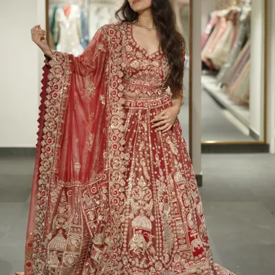 A full view of a breathtaking maroon bridal lehenga. The intricate, dense embroidery covers the entire skirt and blouse, creating a look of pure opulence perfect for your wedding ceremony.