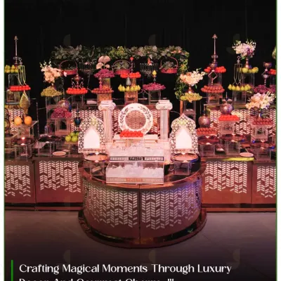 This modern buffet setup features a striking geometric-patterned counter with mirrored surfaces, complemented by an elaborate, multi-tiered fruit and dessert display.