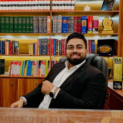 In my office, surrounded by the tools of my trade. Every book on these shelves represents knowledge that I use to build strong cases and secure justice for my clients.