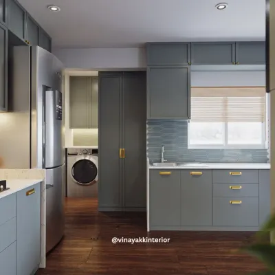 This view of the powder-blue kitchen shows how I seamlessly integrated a utility area. A discreet pocket door slides away to reveal the washing machine, keeping the main kitchen area looking clean and uncluttered.