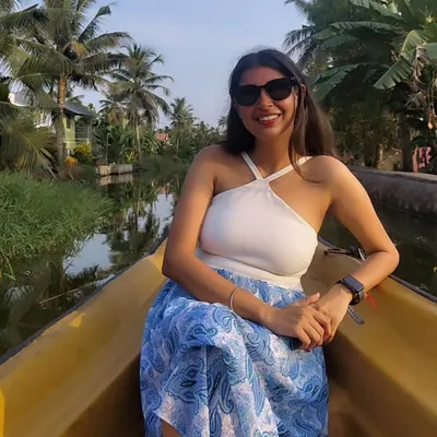 Exploring the serene backwaters of Alleppey. For a boat ride, I chose a comfortable and chic white halter top with a flowy blue printed skirt.