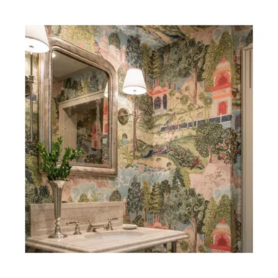 This is the powder room of dreams, wrapped entirely in a dreamy, exotic, and colourful scenic wallpaper. This is a perfect example of how to create a fully immersive and transportive experience in a small space.