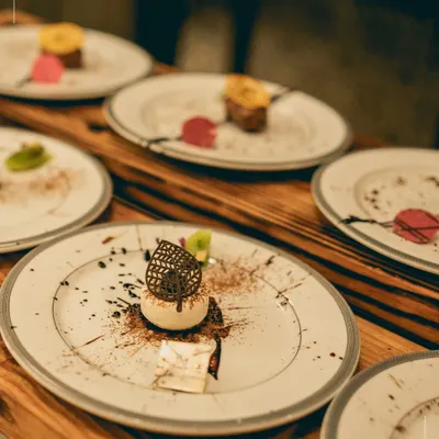 A row of beautifully plated desserts, showcasing our range and artistry. Every wedding menu we create is a story, and the final chapter is always sweet.