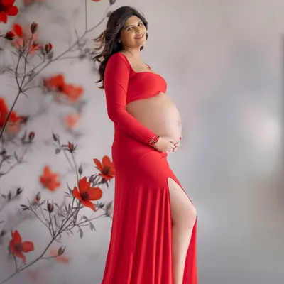 A bold and beautiful portrait in red. This gown from my studio wardrobe, with its thigh-high slit and bare-bump design, is perfect for moms who want to celebrate their changing body.