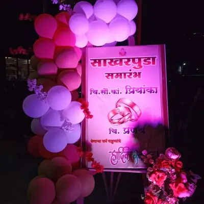 A simple and elegant welcome sign for a 'Sakharpuda' or engagement ceremony, decorated with a balloon arch.