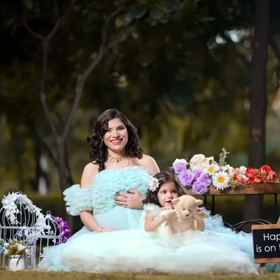 Happiness is on the way, and big sister is ready to welcome it. This sweet outdoor family portrait captures a beautiful moment between mother and daughter.