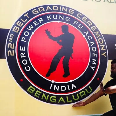 Posing in front of the banner for our 22nd Belt Grading Ceremony in Bengaluru. These events are a major milestone for our academy and our students.